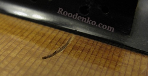 Dent on the soundboard from the string