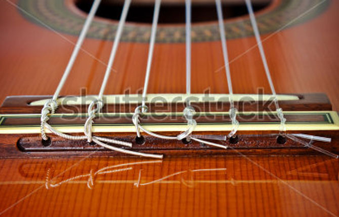 The guitar strings are tied incorrectly